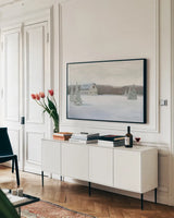 Holiday Winter Barn by James Wiens. shown as a framed stretched canvas in a living room above a console. Available as a archival giclee rolled canvas, fine art paper, or poster print. SKU 75657i.