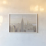 Manhattan Dawn Gold and Neutral by James Wiens. shown as a paper print in a white frame. Available as a archival giclee rolled canvas, fine art paper, or poster print. SKU 69084i.