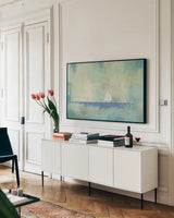 Sailboat Dream by James Wiens. shown as a framed stretched canvas in a living room above a console. Available as a archival giclee rolled canvas, fine art paper, or poster print. SKU 20360i.