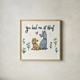 Dogs in the Garden III by Janelle Penner. Shown in a natural wood glass frame for a timeless modern aesthetic. Available as an archival giclee rolled canvas, fine art paper, or poster print. SKU 36679a.