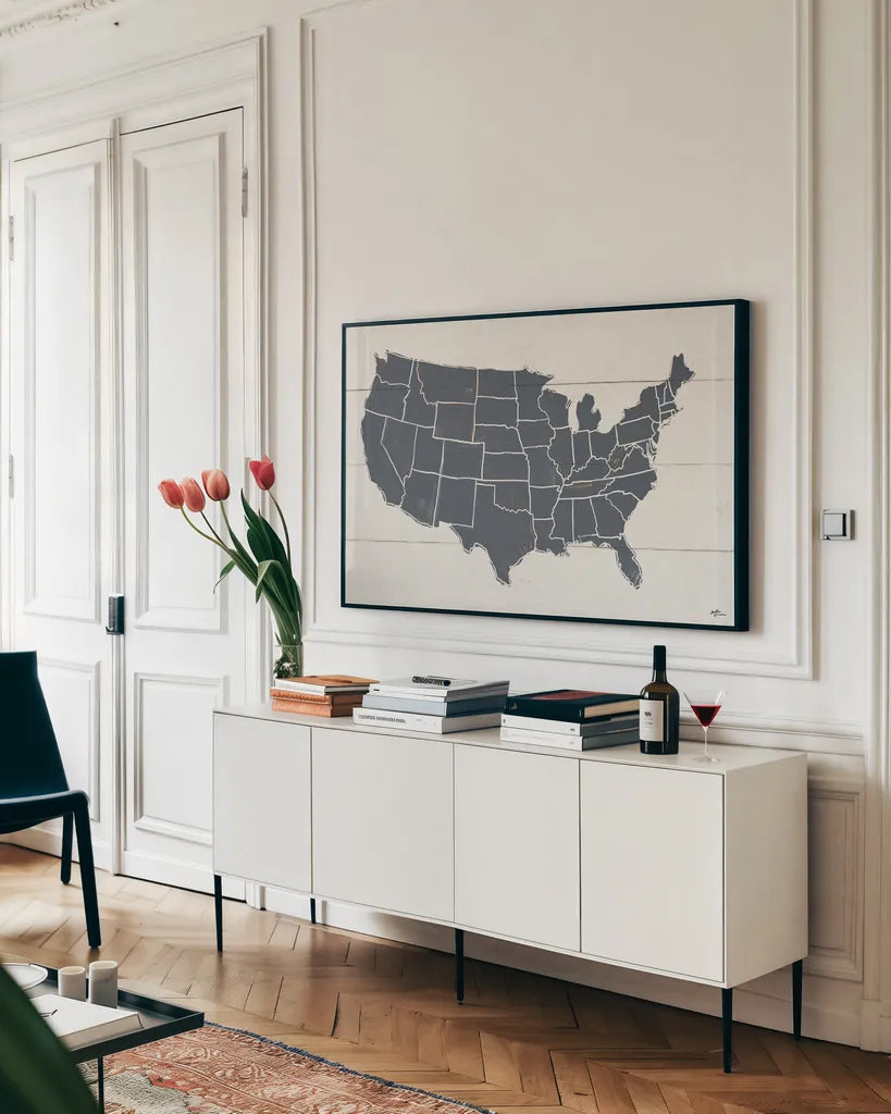 Peace and Lodge USA Map Gray by Janelle Penner. shown as a framed stretched canvas in a living room above a console. Available as a archival giclee rolled canvas, fine art paper, or poster print. SKU 88477i.