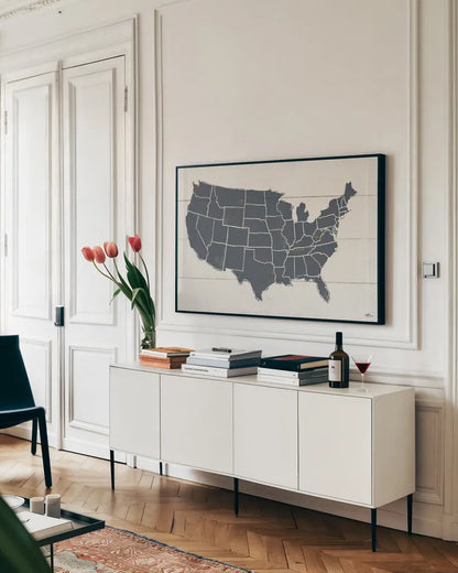 Peace and Lodge USA Map Gray by Janelle Penner. shown as a framed stretched canvas in a living room above a console. Available as a archival giclee rolled canvas, fine art paper, or poster print. SKU 88477i.