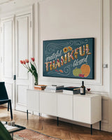 Thankful I Blue by Janelle Penner. shown as a framed stretched canvas in a living room above a console. Available as a archival giclee rolled canvas, fine art paper, or poster print. SKU 43098i.