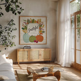 Thankful II White Leaves by Janelle Penner. Shown in a natural wood frame in a cozy modern living room. Available as an archival giclee rolled canvas, fine art paper, or poster print. SKU 47586a.