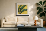 Welcome to Paradise XI Yellow by Janelle Penner. Displayed in a glass frame with matte in a clean modern living room. Available as an archival giclee rolled canvas, fine art paper, or poster print. SKU 55553a.