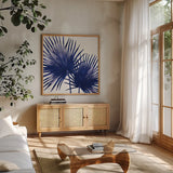 Welcome to Paradise XII Indigo by Janelle Penner. Shown in a natural wood frame in a cozy modern living room. Available as an archival giclee rolled canvas, fine art paper, or poster print. SKU 34078a.