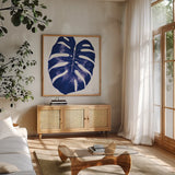 Welcome to Paradise XIII Indigo by Janelle Penner. Shown in a natural wood frame in a cozy modern living room. Available as an archival giclee rolled canvas, fine art paper, or poster print. SKU 34079a.