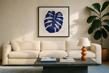 Welcome to Paradise XIII Indigo by Janelle Penner. Displayed in a glass frame with matte in a clean modern living room. Available as an archival giclee rolled canvas, fine art paper, or poster print. SKU 34079a.