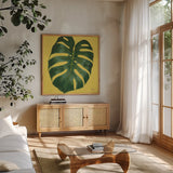 Welcome to Paradise XIII Yellow by Janelle Penner. Shown in a natural wood frame in a cozy modern living room. Available as an archival giclee rolled canvas, fine art paper, or poster print. SKU 55554a.