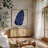 Welcome to Paradise XV Indigo by Janelle Penner. Shown in a natural wood frame in a cozy modern living room. Available as an archival giclee rolled canvas, fine art paper, or poster print. SKU 34081a.