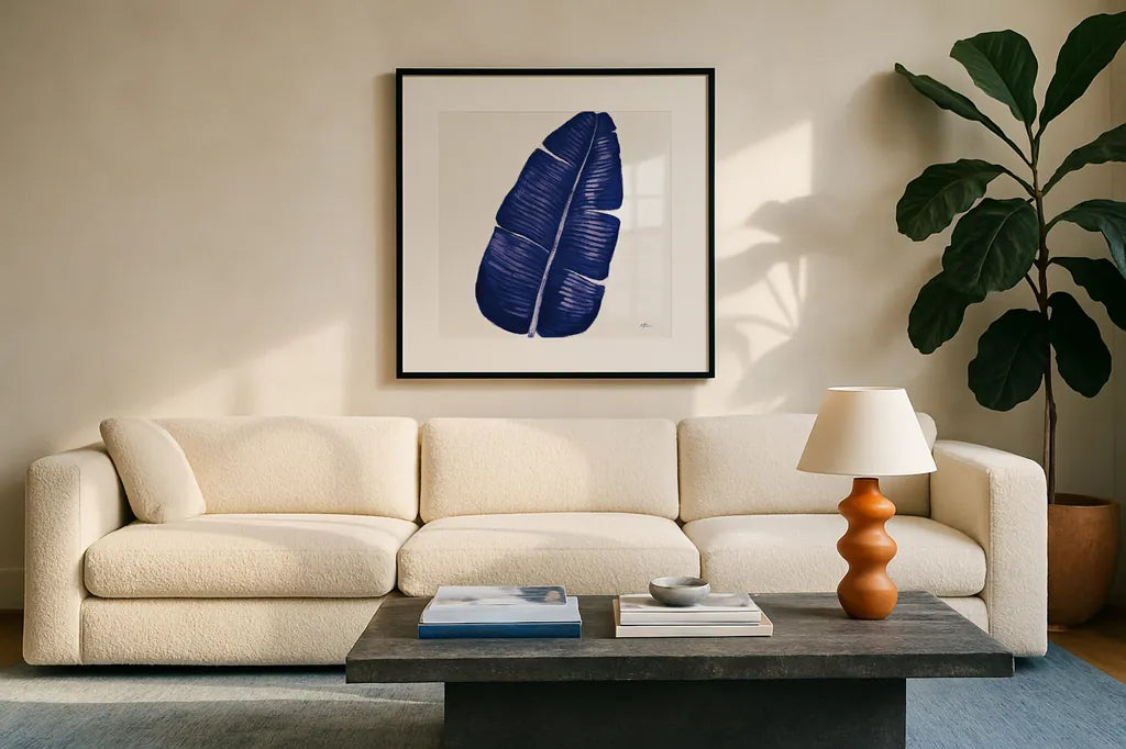 Welcome to Paradise XV Indigo by Janelle Penner. Displayed in a glass frame with matte in a clean modern living room. Available as an archival giclee rolled canvas, fine art paper, or poster print. SKU 34081a.