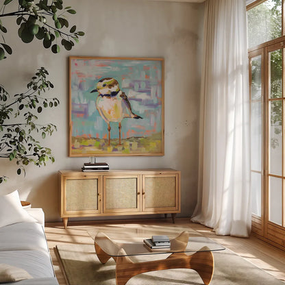 Coastal Plover II by Jeanette Vertentes. Shown in a natural wood frame in a cozy modern living room. Available as an archival giclee rolled canvas, fine art paper, or poster print. SKU 55180a.