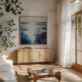 Glisten by Jeanette Vertentes. Shown in a natural wood frame in a cozy modern living room. Available as an archival giclee rolled canvas, fine art paper, or poster print. SKU 103176a.