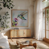 Hummingbird II by Jeanette Vertentes. Shown in a natural wood frame in a cozy modern living room. Available as an archival giclee rolled canvas, fine art paper, or poster print. SKU 63455a.