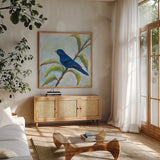 Indigo Bunting by Jeanette Vertentes. Shown in a natural wood frame in a cozy modern living room. Available as an archival giclee rolled canvas, fine art paper, or poster print. SKU 63459a.