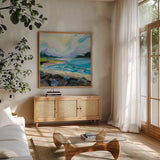 The Coastline by Jeanette Vertentes. Shown in a natural wood frame in a cozy modern living room. Available as an archival giclee rolled canvas, fine art paper, or poster print. SKU 59571a.