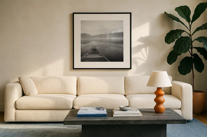 Calm Waters Canoe I BW by Jess Aiken. Displayed in a glass frame with matte in a clean modern living room. Available as an archival giclee rolled canvas, fine art paper, or poster print. SKU 83655a.