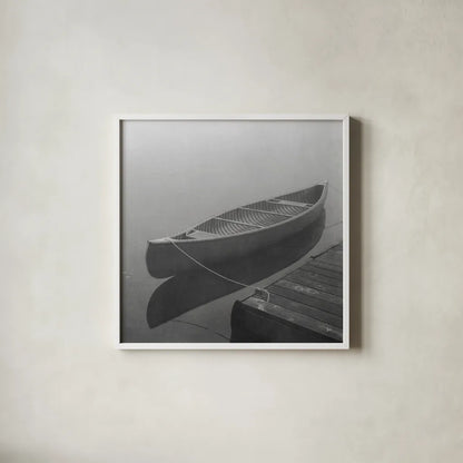 Calm Waters Canoe II BW by Jess Aiken. Shown in a crisp white glass frame for a clean and minimalist style. Available as an archival giclee rolled canvas, fine art paper, or poster print. SKU 83656a.
