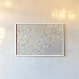 Seaside Blossoms V Neutral by Jess Aiken. shown as a paper print in a white frame. Available as a archival giclee rolled canvas, fine art paper, or poster print. SKU 34921i.