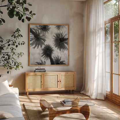 Amongst the Palms Square by Jim Dratfield. Shown in a natural wood frame in a cozy modern living room. Available as an archival giclee rolled canvas, fine art paper, or poster print. SKU 30220a.