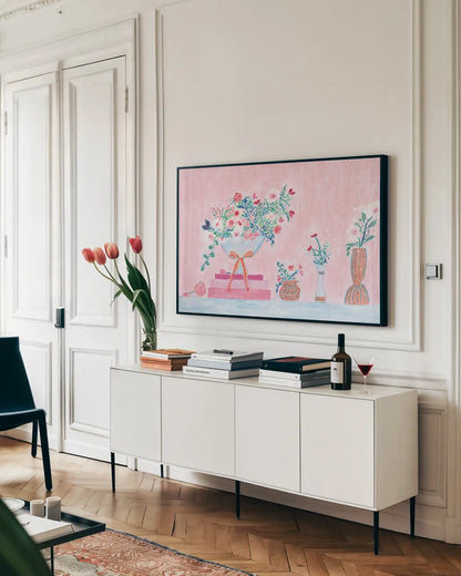 Flower Vases and Books Pink by Jocelyn Elizabeth. shown as a framed stretched canvas in a living room above a console. Available as a archival giclee rolled canvas, fine art paper, or poster print. SKU 100970i.