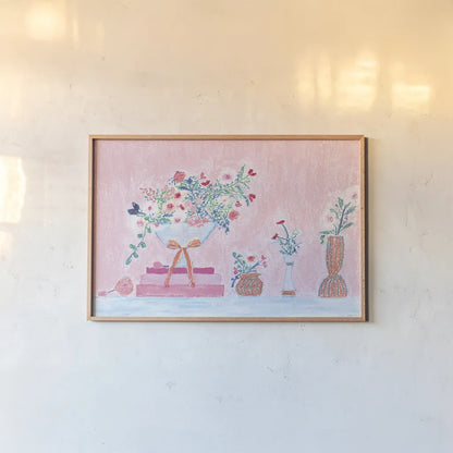 Flower Vases and Books Pink by Jocelyn Elizabeth. shown as a paper print in a natural frame. Available as a archival giclee rolled canvas, fine art paper, or poster print. SKU 100970i.