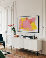 Lemonade Burst by Jocelyn Elizabeth. shown as a framed stretched canvas in a living room above a console. Available as a archival giclee rolled canvas, fine art paper, or poster print. SKU 95423i.
