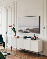 Misty Shore on the Rocks by Jocelyn Elizabeth. shown as a framed stretched canvas in a living room above a console. Available as a archival giclee rolled canvas, fine art paper, or poster print. SKU 100324i.