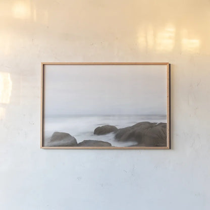 Misty Shore on the Rocks by Jocelyn Elizabeth. shown as a paper print in a natural frame. Available as a archival giclee rolled canvas, fine art paper, or poster print. SKU 100324i.