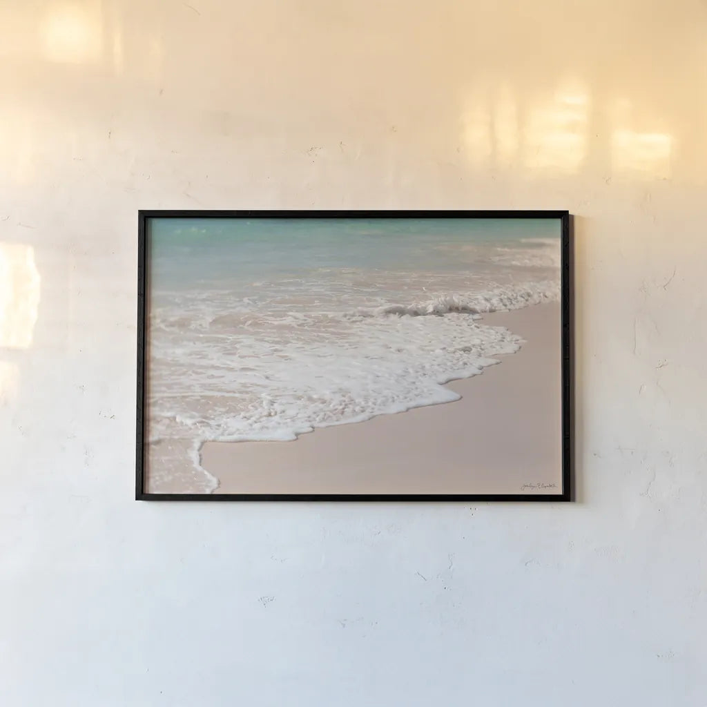 Pink Sand Shoreline by Jocelyn Elizabeth. shown as a paper print in a black flame. Available as a archival giclee rolled canvas, fine art paper, or poster print. SKU 100325i.