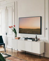 Sunrise over the Dunes by Jocelyn Elizabeth. shown as a framed stretched canvas in a living room above a console. Available as a archival giclee rolled canvas, fine art paper, or poster print. SKU 102107i.