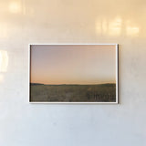 Sunrise over the Dunes by Jocelyn Elizabeth. shown as a paper print in a white frame. Available as a archival giclee rolled canvas, fine art paper, or poster print. SKU 102107i.