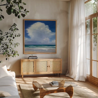 Beach Clouds II by Julia Purinton. Shown in a natural wood frame in a cozy modern living room. Available as an archival giclee rolled canvas, fine art paper, or poster print. SKU 33436a.