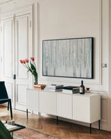 Birches in Winter Blue Gray by Julia Purinton. shown as a framed stretched canvas in a living room above a console. Available as a archival giclee rolled canvas, fine art paper, or poster print. SKU 21964i.