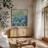 Bright Hydrangea II by Julia Purinton. Shown in a natural wood frame in a cozy modern living room. Available as an archival giclee rolled canvas, fine art paper, or poster print. SKU 14834a.