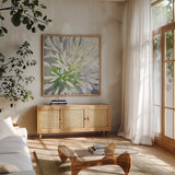 Cleome Splash II by Julia Purinton. Shown in a natural wood frame in a cozy modern living room. Available as an archival giclee rolled canvas, fine art paper, or poster print. SKU 47856a.