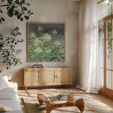 Farmhouse Cleome II by Julia Purinton. Shown in a natural wood frame in a cozy modern living room. Available as an archival giclee rolled canvas, fine art paper, or poster print. SKU 47858a.