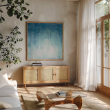 Into the Blue I by Julia Purinton. Shown in a natural wood frame in a cozy modern living room. Available as an archival giclee rolled canvas, fine art paper, or poster print. SKU 73766a.