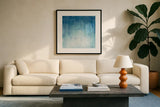 Into the Blue I by Julia Purinton. Displayed in a glass frame with matte in a clean modern living room. Available as an archival giclee rolled canvas, fine art paper, or poster print. SKU 73766a.