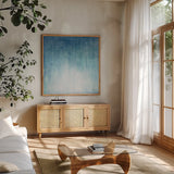 Into the Blue II by Julia Purinton. Shown in a natural wood frame in a cozy modern living room. Available as an archival giclee rolled canvas, fine art paper, or poster print. SKU 73767a.