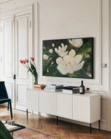 Magnolia Blooms Crop No Petal by Julia Purinton. shown as a framed stretched canvas in a living room above a console. Available as a archival giclee rolled canvas, fine art paper, or poster print. SKU 30923i.