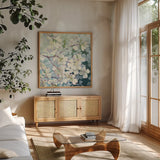 Magnolia Delight by Julia Purinton. Shown in a natural wood frame in a cozy modern living room. Available as an archival giclee rolled canvas, fine art paper, or poster print. SKU 17527a.