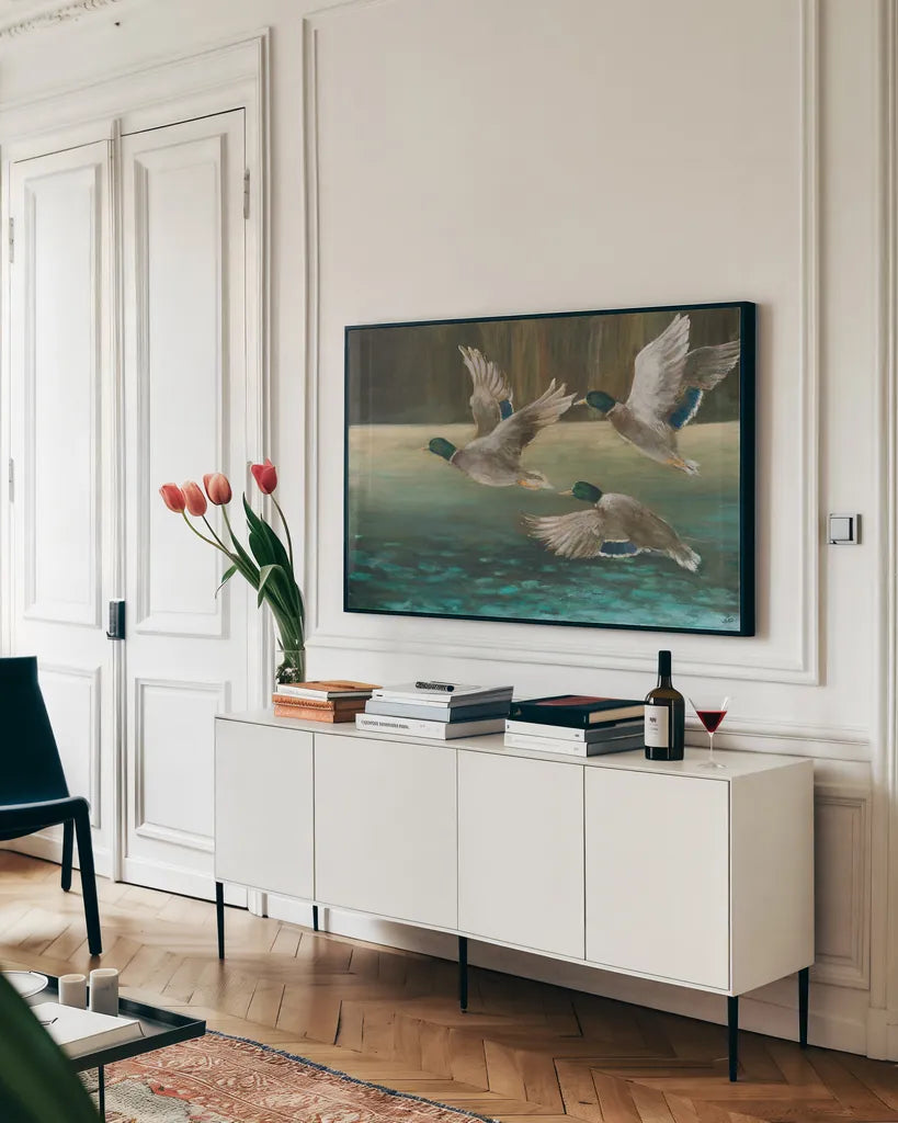 Mallard Flight by Julia Purinton. shown as a framed stretched canvas in a living room above a console. Available as a archival giclee rolled canvas, fine art paper, or poster print. SKU 97245i.