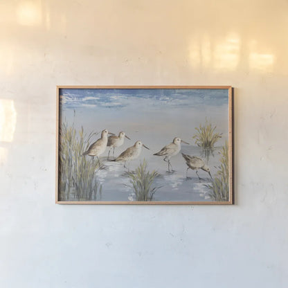 Sandpiper Stroll by Julia Purinton. shown as a paper print in a natural frame. Available as a archival giclee rolled canvas, fine art paper, or poster print. SKU 99749i.