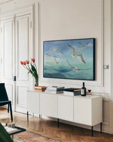 Sea Flight by Julia Purinton. shown as a framed stretched canvas in a living room above a console. Available as a archival giclee rolled canvas, fine art paper, or poster print. SKU 66554i.