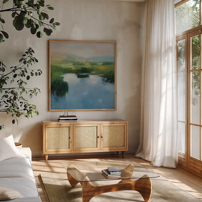 Still Water Blue by Julia Purinton. Shown in a natural wood frame in a cozy modern living room. Available as an archival giclee rolled canvas, fine art paper, or poster print. SKU 86272a.
