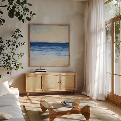 True Blue Ocean I by Julia Purinton. Shown in a natural wood frame in a cozy modern living room. Available as an archival giclee rolled canvas, fine art paper, or poster print. SKU 24586a.