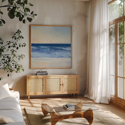True Blue Ocean II by Julia Purinton. Shown in a natural wood frame in a cozy modern living room. Available as an archival giclee rolled canvas, fine art paper, or poster print. SKU 24587a.