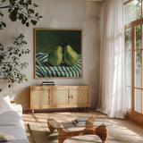 A Pair of Pears On Tablecloth by Kate Jarvik Birch. Shown in a natural wood frame in a cozy modern living room. Available as an archival giclee rolled canvas, fine art paper, or poster print. SKU 101973a.