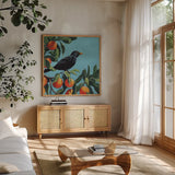 Black Bird On Orange Branch by Kate Jarvik Birch. Shown in a natural wood frame in a cozy modern living room. Available as an archival giclee rolled canvas, fine art paper, or poster print. SKU 101986a.